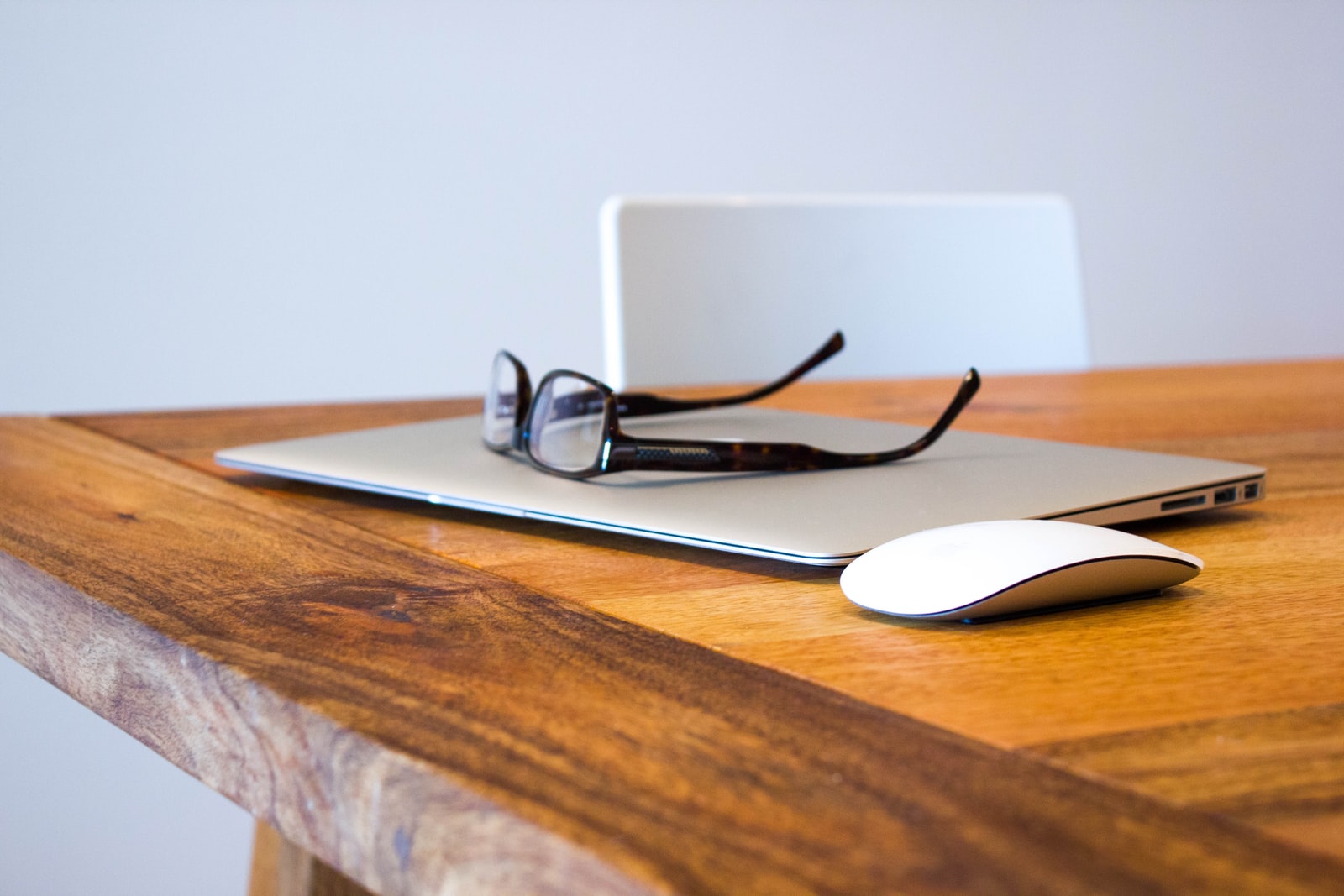 black framed eyeglasses on closed laptop computer