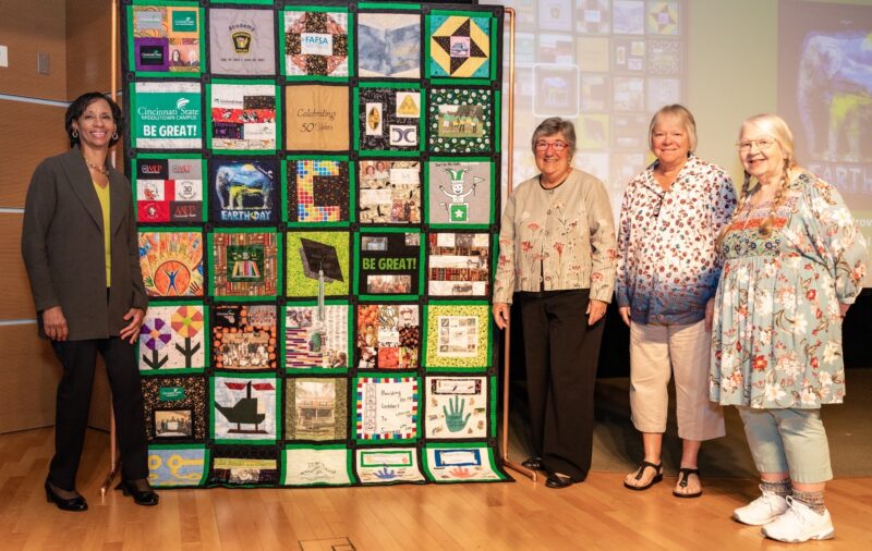 Dr. Monica Posey, Joyce Rimlinger, Diane Stump, Debbie Bogenschutz, and the 50th Anniversary quilt