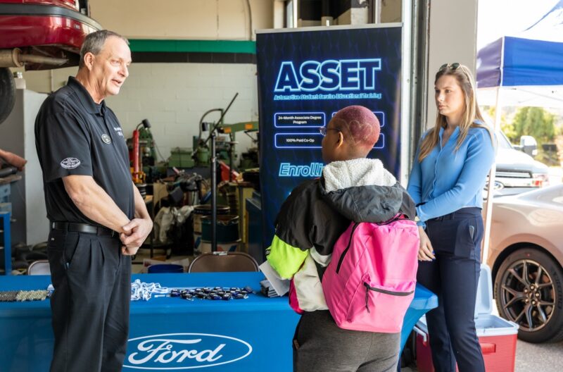 Student talks to Ford representatives at Automotive Career Day