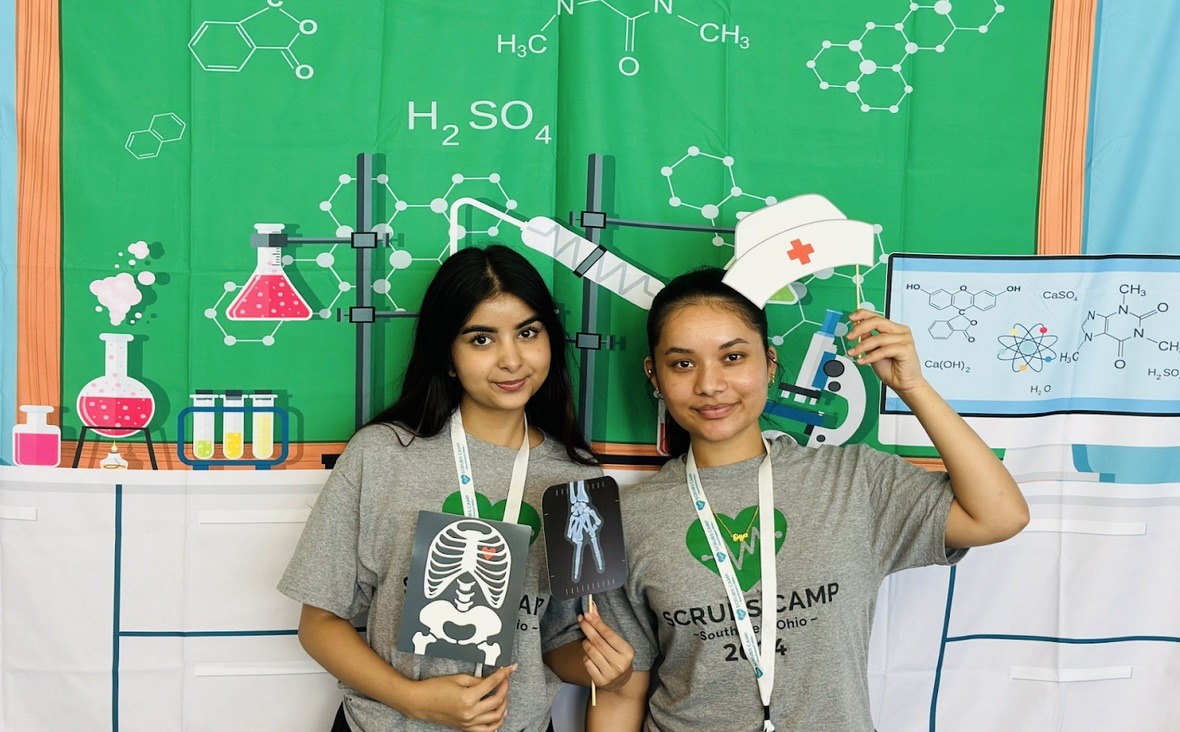 Scrubs Camp 2024 - students with signs representing future careers