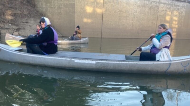 Environmental students collecting water samples from Mill Creek via canoe