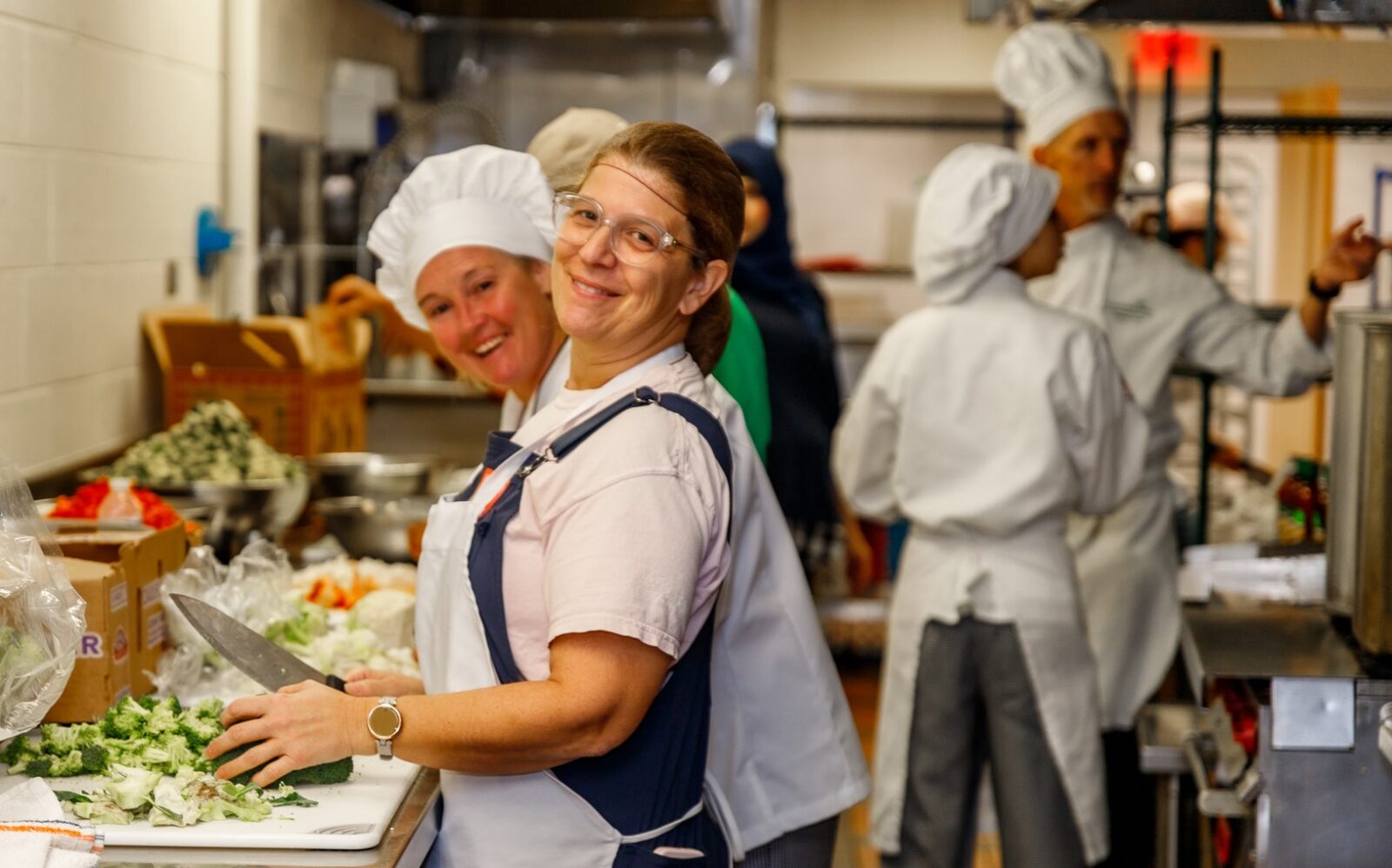 Culinary students assisting other volunteers making soup